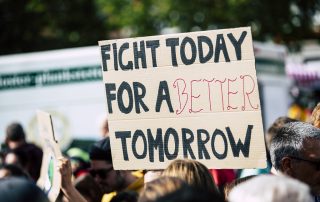 A Person Lobbying For Sustainability At A Climate Change Protest Holds A Sign That Reads Fight Today For A Better Tomorrow